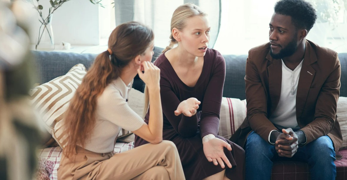 Group of people talking on a couch