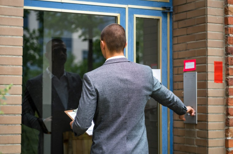 Man knocking on door to collect debt